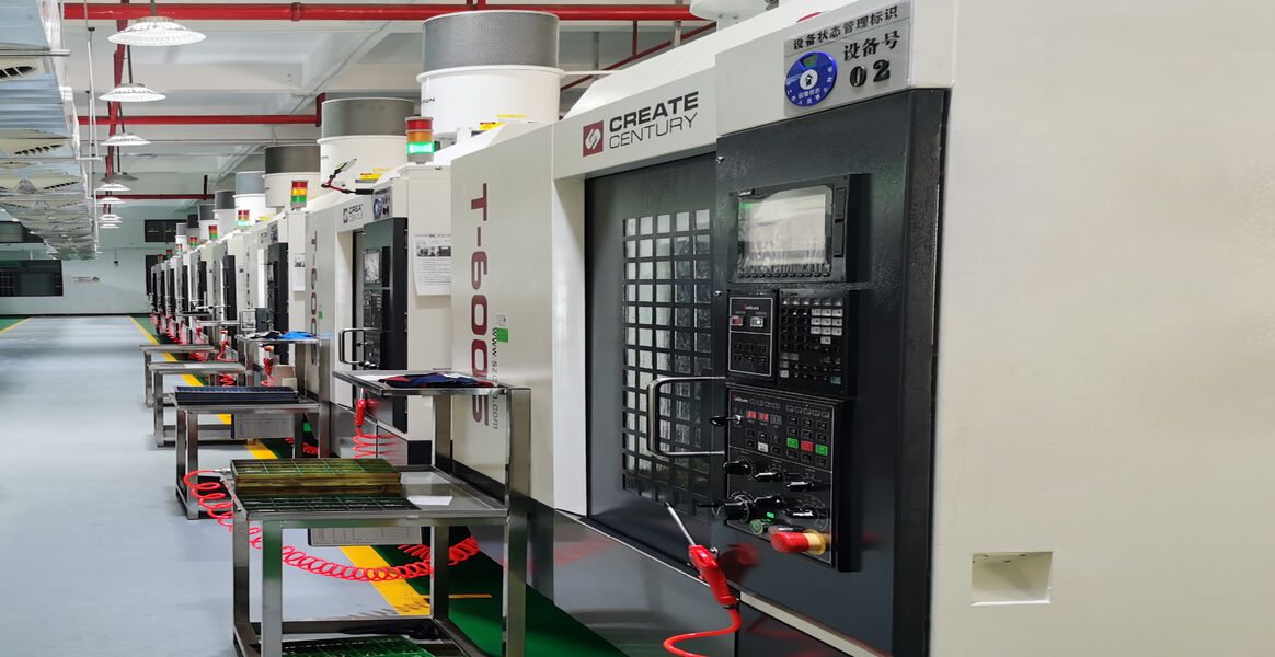 A row of CREATE CENTURY CNC machining centres on the floor, each with its own equipment tag and a trolley of parts alongside.